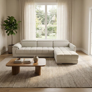 Modern living room with a beige sectional sofa, wooden coffee table, and large window.