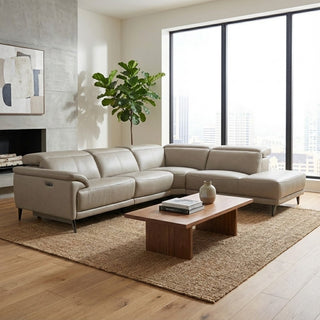 Modern living room with a beige sectional sofa, wooden coffee table, and large windows.