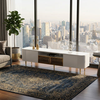 Modern living room with a cityscape view, white tv console, and decorative elements.