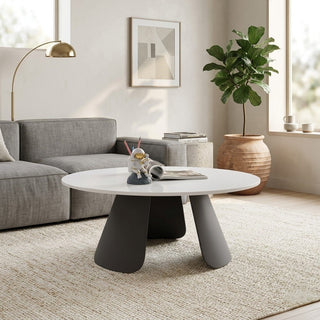 Modern living room with a gray sofa, round marble coffee table, and decorative elements.