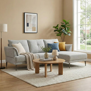 Modern living room with a gray sofa, wooden coffee table, and decorative elements.