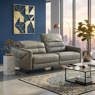 Modern living room with a grey recliner sofa, coffee table, and decorative elements.