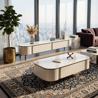 Modern living room with a large window view, coffee table, and decorative items.