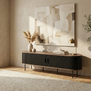 Modern living room with a wooden sideboard, abstract painting, and decorative items.