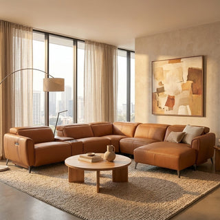 Modern living room with brown leather sectional sofa, round coffee table, and abstract painting.