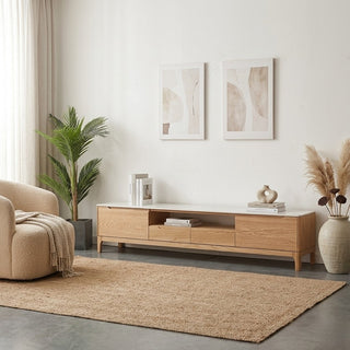 Modern living room with tv console oak, beige armchair, and abstract art on wall.