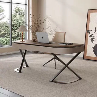 Modern office desk with a laptop in a well-lit room with large windows.