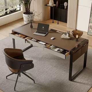 Modern office desk with laptop, mouse, and office supplies in a well-lit room.