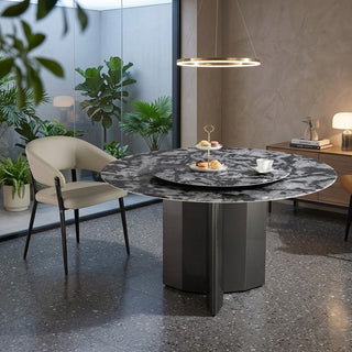 Modern round dining table with marble-like surface in a stylish interior setting.