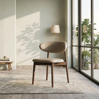 Modern walnut dining chair in a room with a lamp and plants