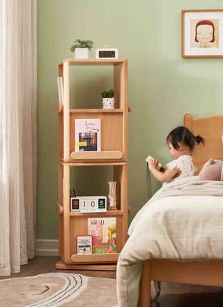 Montessori Rotating Bookshelf next to a bed with a child reading a book in a bedroom setting.