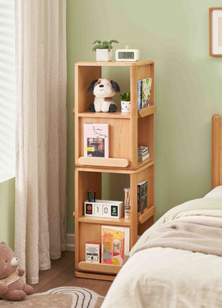 Montessori Rotating Bookshelf with decorative items against a green wall in a bedroom setting.