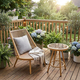 Outdoor deck with wooden chair, balcony side table, and potted plants on a sunny day.