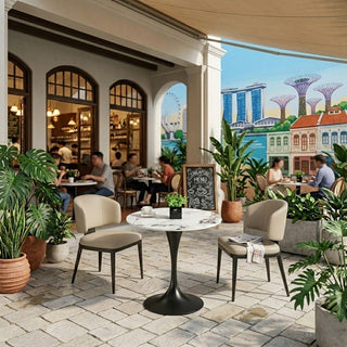 Outdoor dining area with bistro tables, chairs, and potted plants in a restaurant setting.