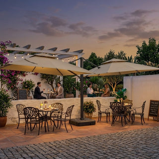 Outdoor dining area with tables, chairs, and bistro parasol under a sunset sky.