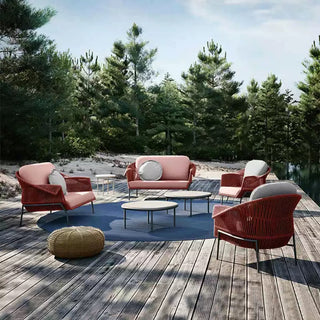 Outdoor furniture set on a wooden deck with a forest background