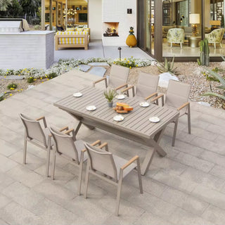 Outdoor patio set with a table and chairs on a stone patio.