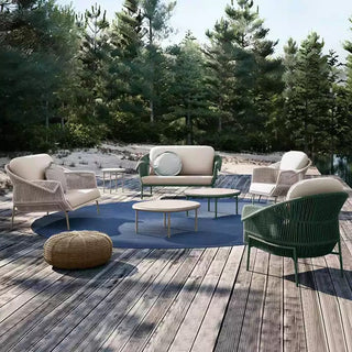 Outdoor patio set with furniture on a wooden deck surrounded by trees.