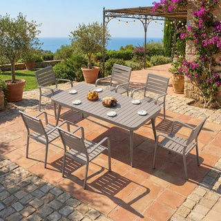 Outdoor patio set with table and chairs on a brick patio with ocean view