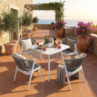 Outdoor patio setting balcony table chair set of 4 and decorative elements on a sunny day.