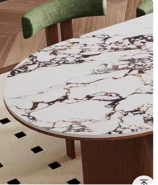 Round marble table with a patterned surface in a room setting