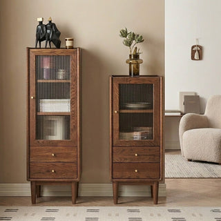 Two walnut cabinets with glass doors in a living room setting.