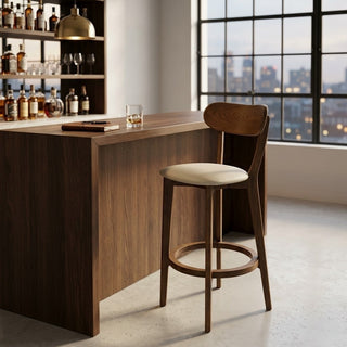 Wooden bar counter stool in a room with large windows showing a cityscape.