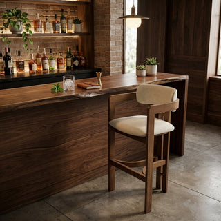 Wooden bar stool and a well-stocked bar in a cozy room.