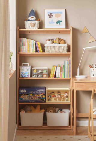 Wooden bookshelf with books, toys, and a desk in a child's room.