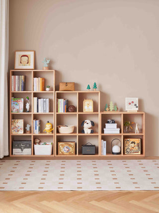 Wooden bookshelf with decorative items against a beige wall