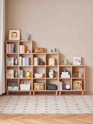 Wooden bookshelf with various items against a beige wall