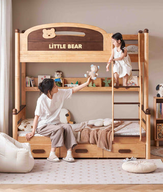 Wooden bunk bed with 'Little Bear' branding, child climbing up, and adult sitting on the bottom bunk.