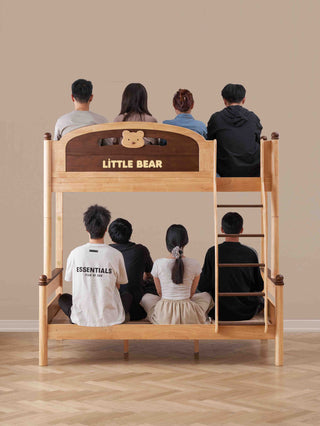 Wooden bunk bed with 'Little Bear' branding, people sitting on it, beige wall background