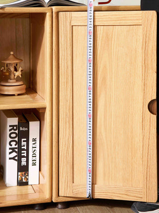 Wooden cabinet with books and a measuring tape