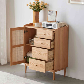 Wooden cabinet with open door, drawers, and decorative items on a light gray floor.