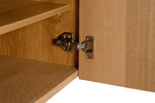 Wooden cabinet with open door showing hinge detail