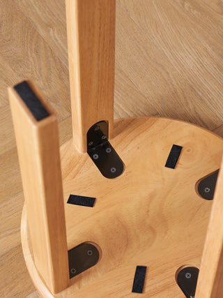 Wooden chair with metal brackets on a wooden floor