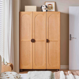 Wooden childs wardrobe with three doors in a bedroom setting