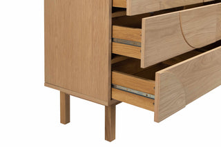 Wooden dresser with open drawers on a white background