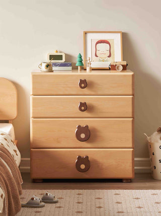 Wooden kids dresser with bear-shaped handles in a bedroom setting