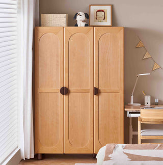 Wooden kids wardrobe in a room with a desk and decor items.