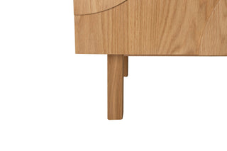 Wooden leg of a piece of furniture on a white background