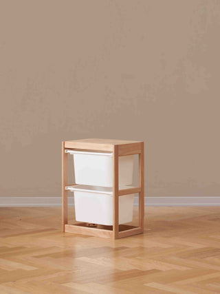 Wooden storage unit with white bins on a wooden floor 