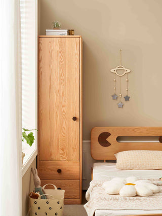 Wooden wardrobe and bed in a bedroom with decorative elements.