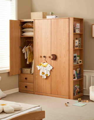 Wooden wardrobe with open doors in a room with a bed and window.