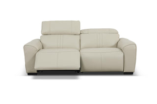 Beige leather sofa reclined on a white background
