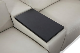 Black rotatable tray on beige sectional sofa
