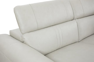 Close-up of a light gray sectional sofa with visible stitching.