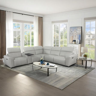Modern living room with a gray sectional recliner sofa, coffee table, and decorative items.