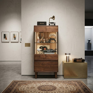 black walnut display cabinet with decorative items in a modern interior setting.